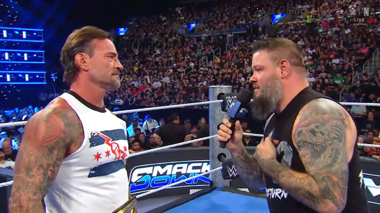 Punk and Owens talking in the ring