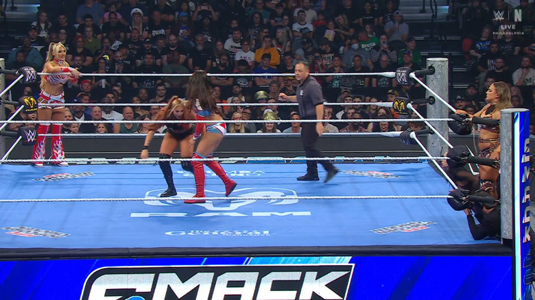 All four women inside and around the ring