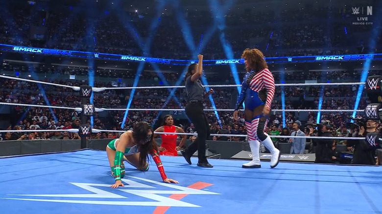Jax standing over Green inside the ring