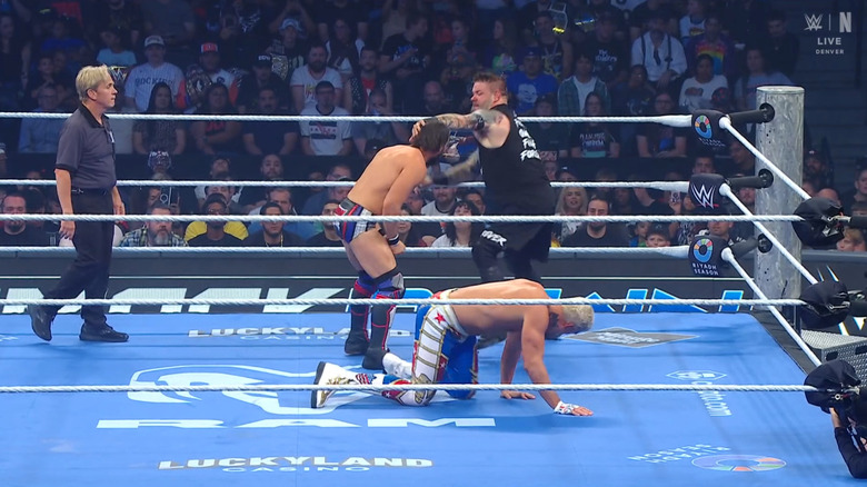 All three men inside the ring